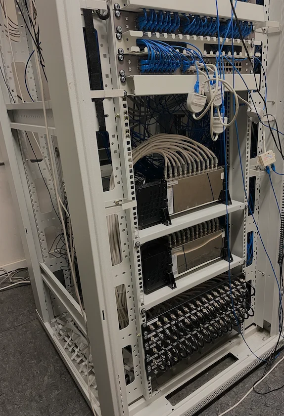 Network equipment and blue and white cabling inside an equipment rack
