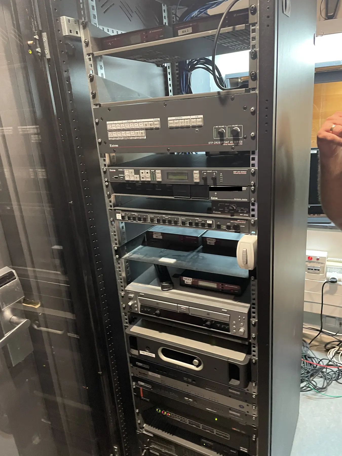 Communications and audiovisual equipment installed in a tall rack inside the residence