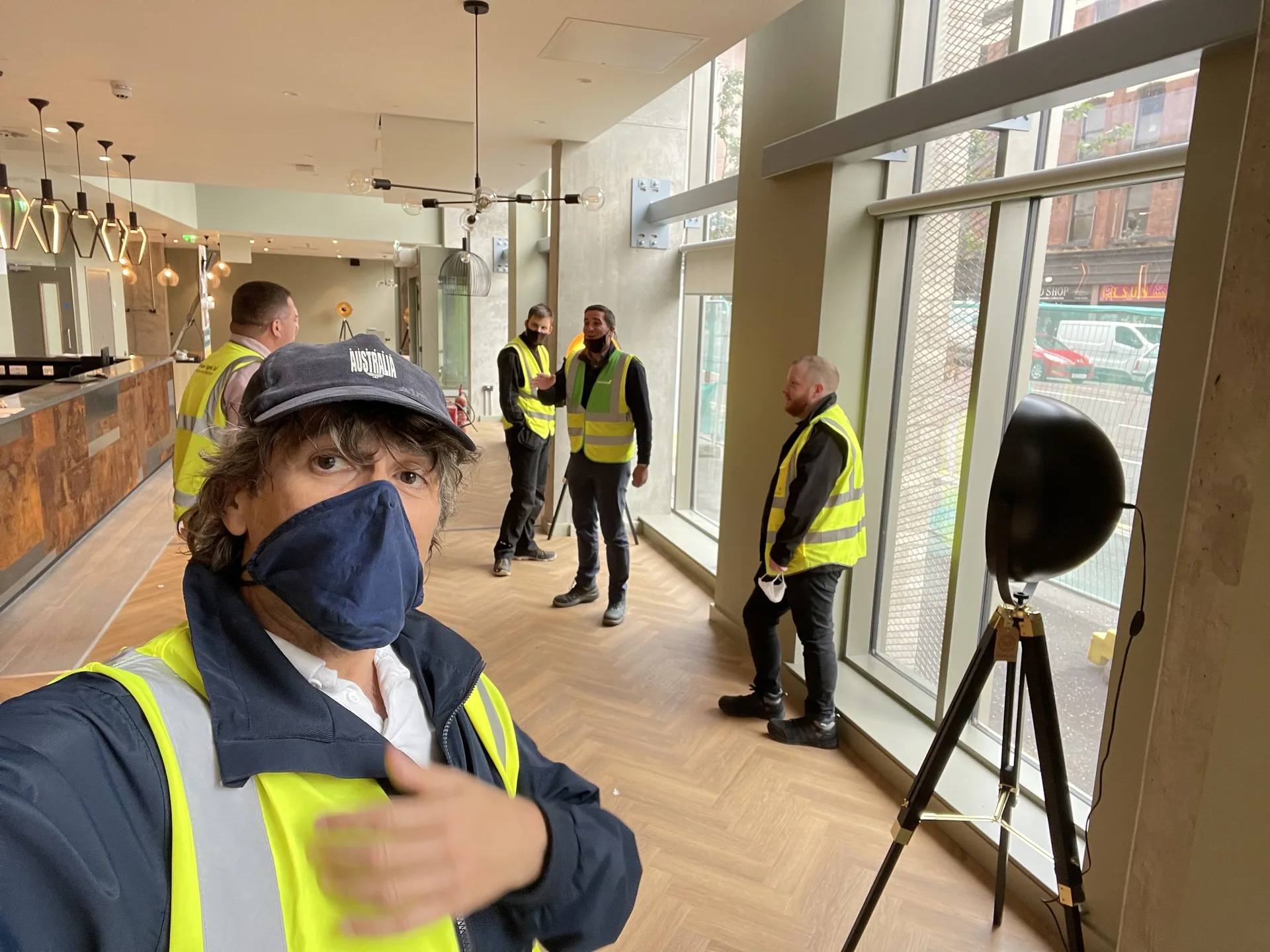 On-site team members in high-visibility vests inside the Belfast residence lobby during fit-out