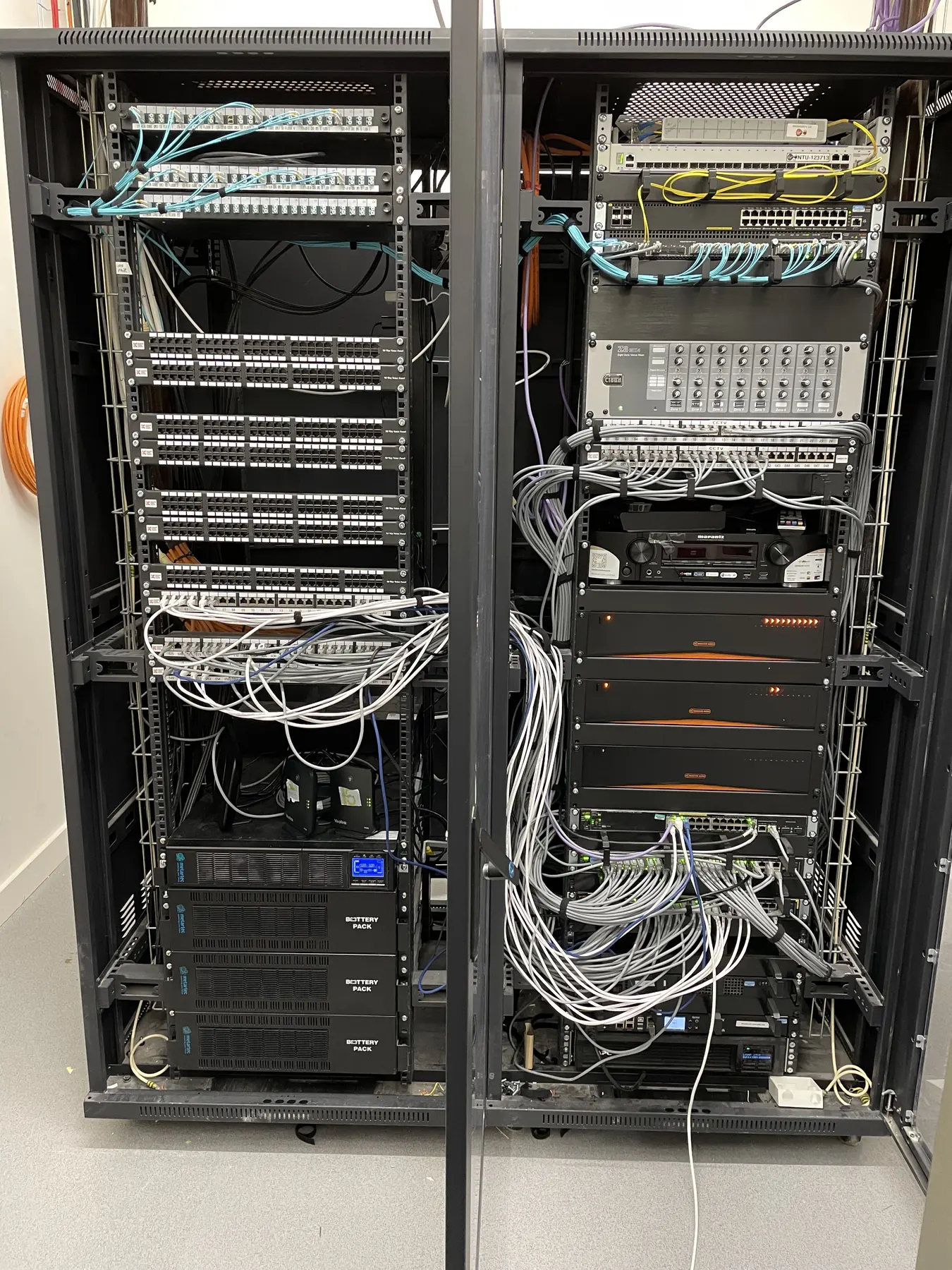Two equipment racks containing network, communications and power equipment in the residence data room
