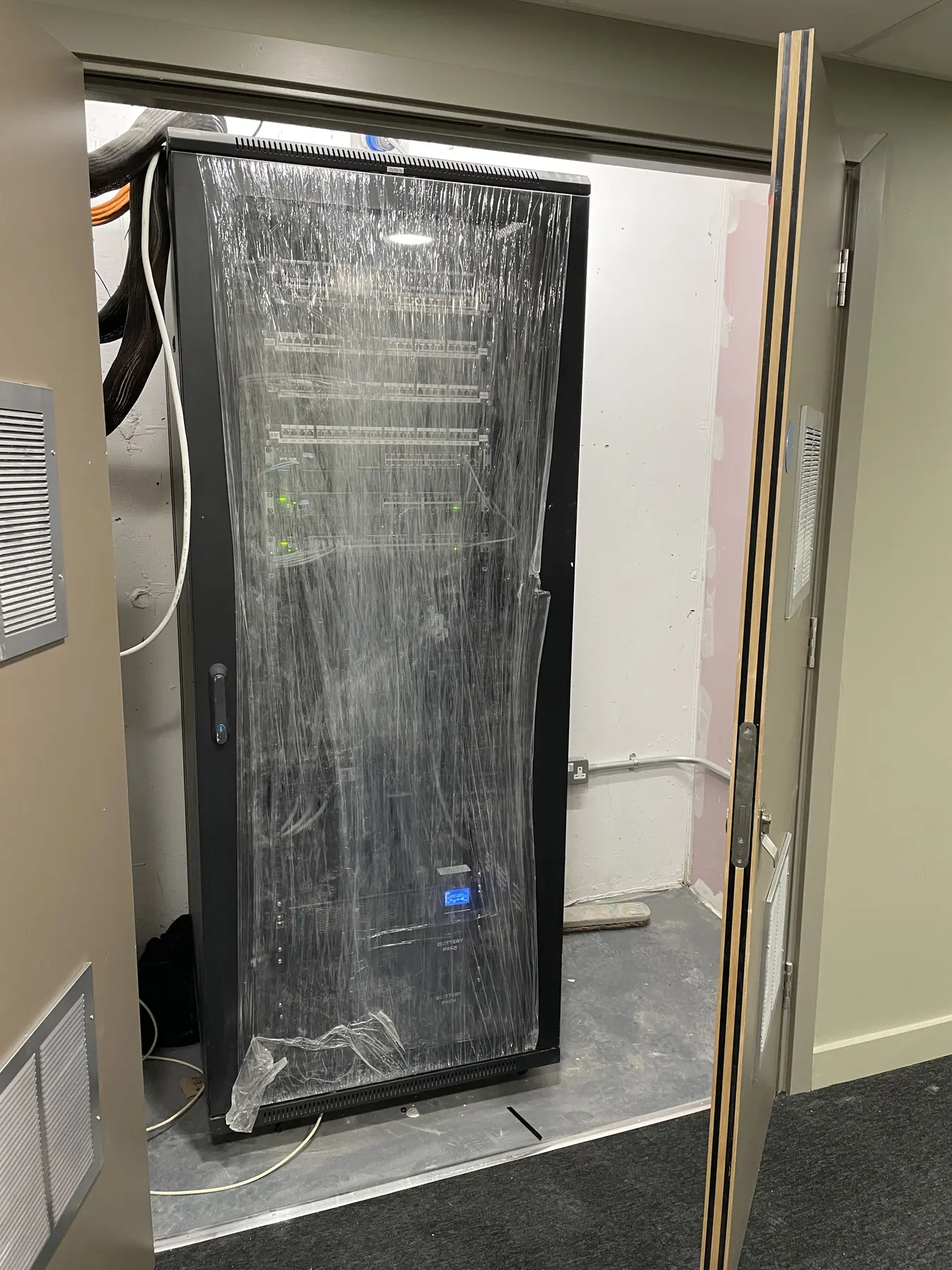 Equipment rack protected with temporary wrapping during building fit-out